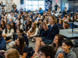 A large group of students gather for a meeting