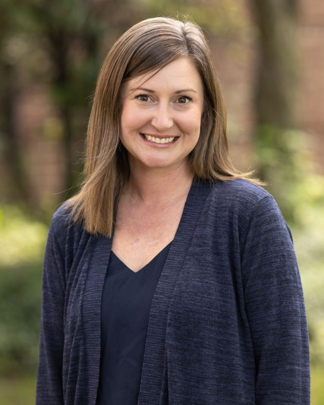 Woman smiles for professional headshot