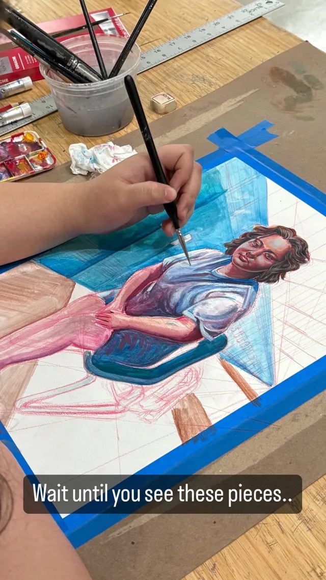Photograph of a hand painting a portrait of a young woman