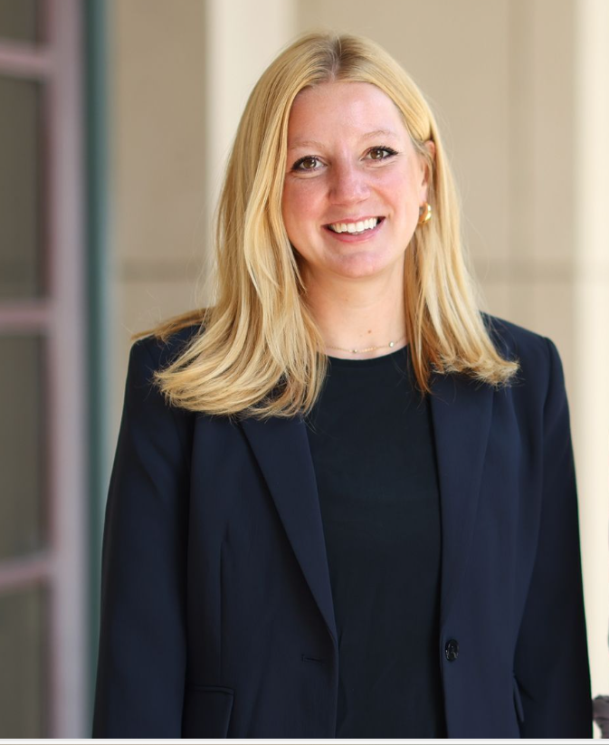 Woman in navy blazer poses for professional headshot