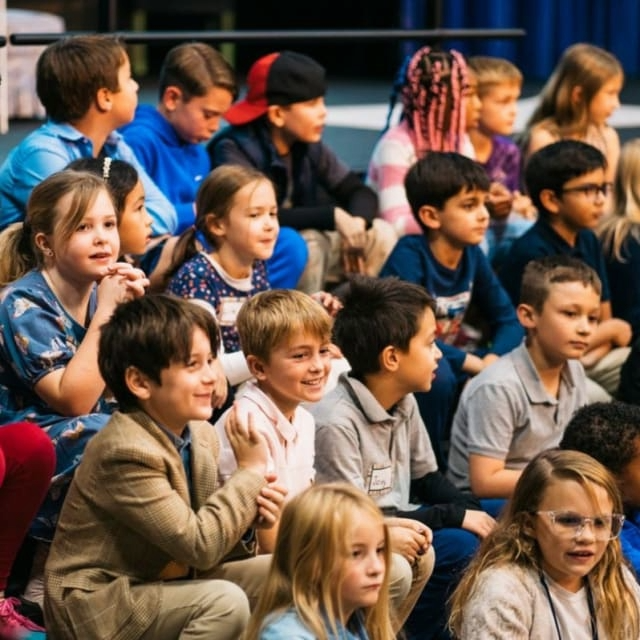 A group of elementary school students sitting on risers