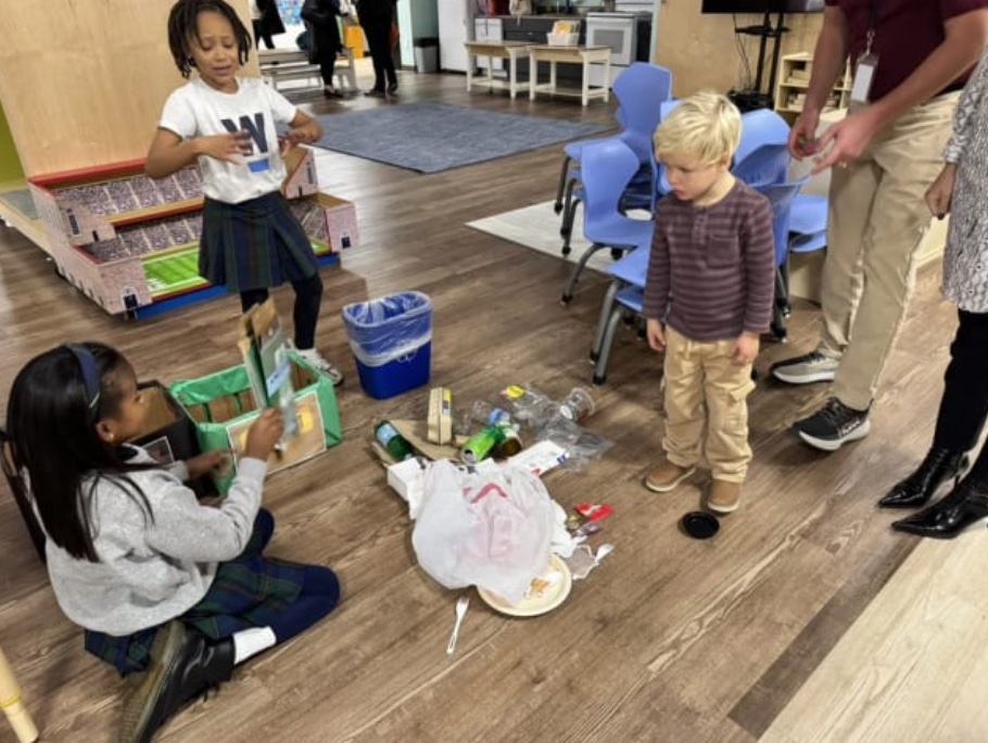 A group of young children play on the ground
